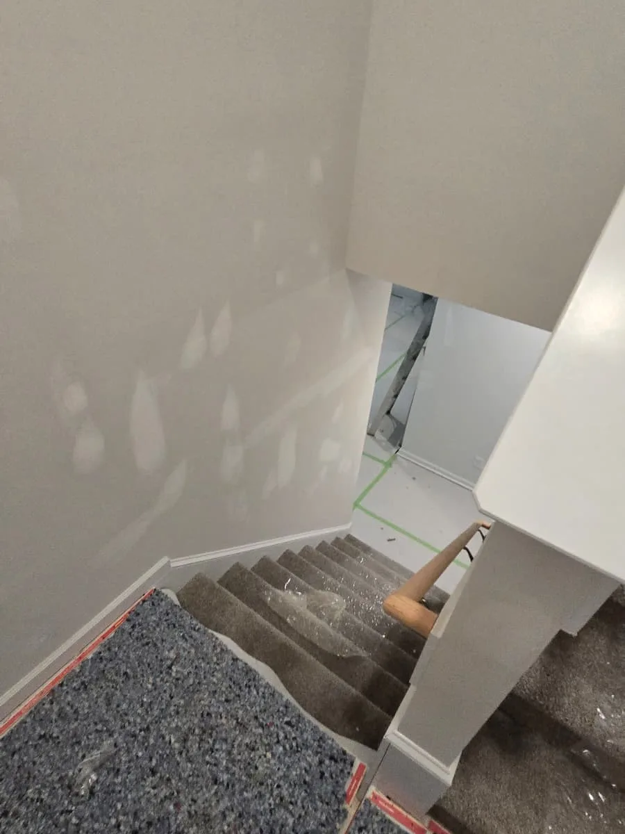 Painted stairwell in a new build with the walls finished and the trim in white