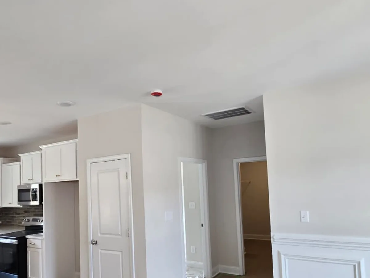 Kitchen with white wainscoting and trim finished against gray walls