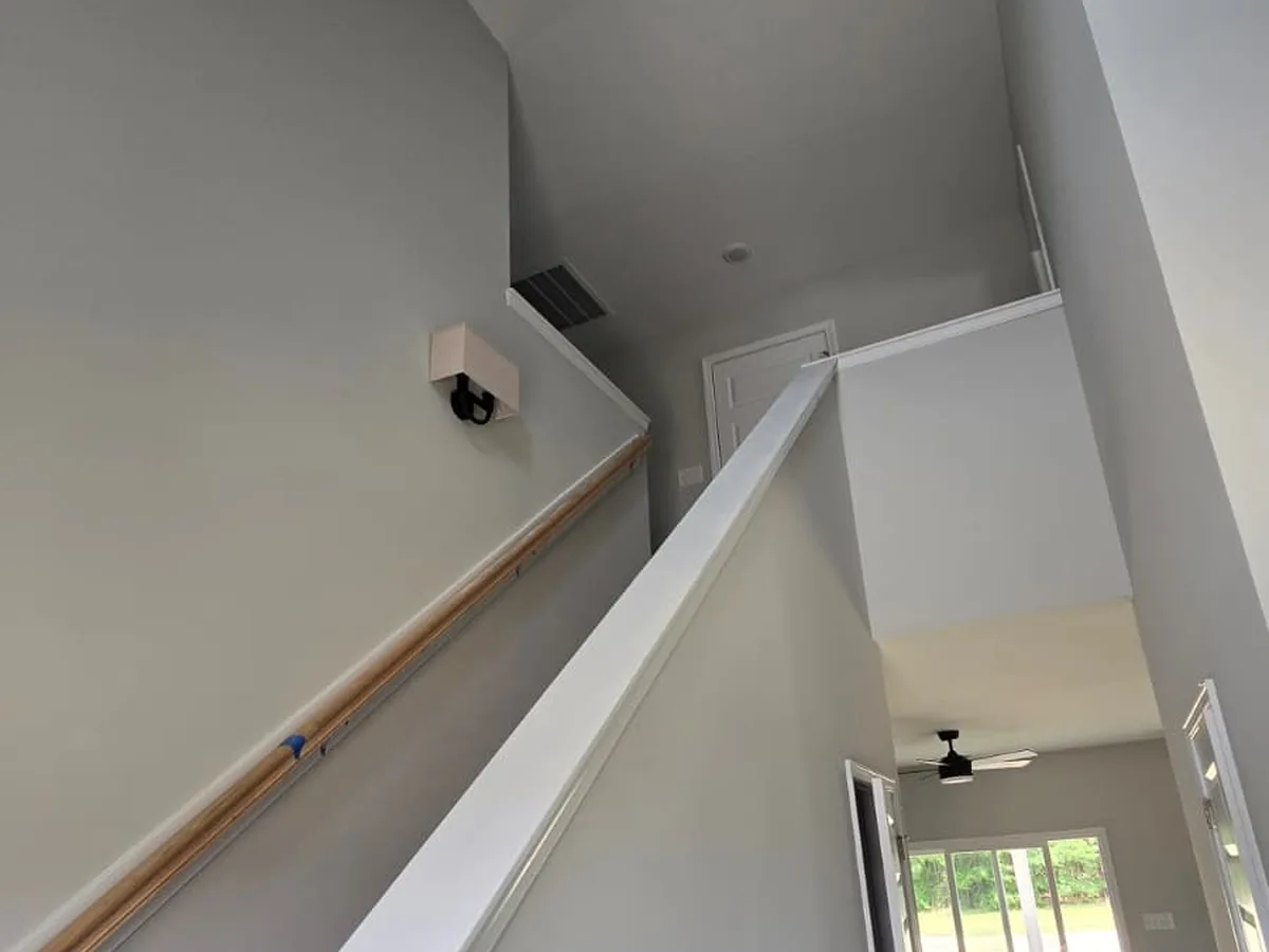 Stair landing with a painted half wall and white cap